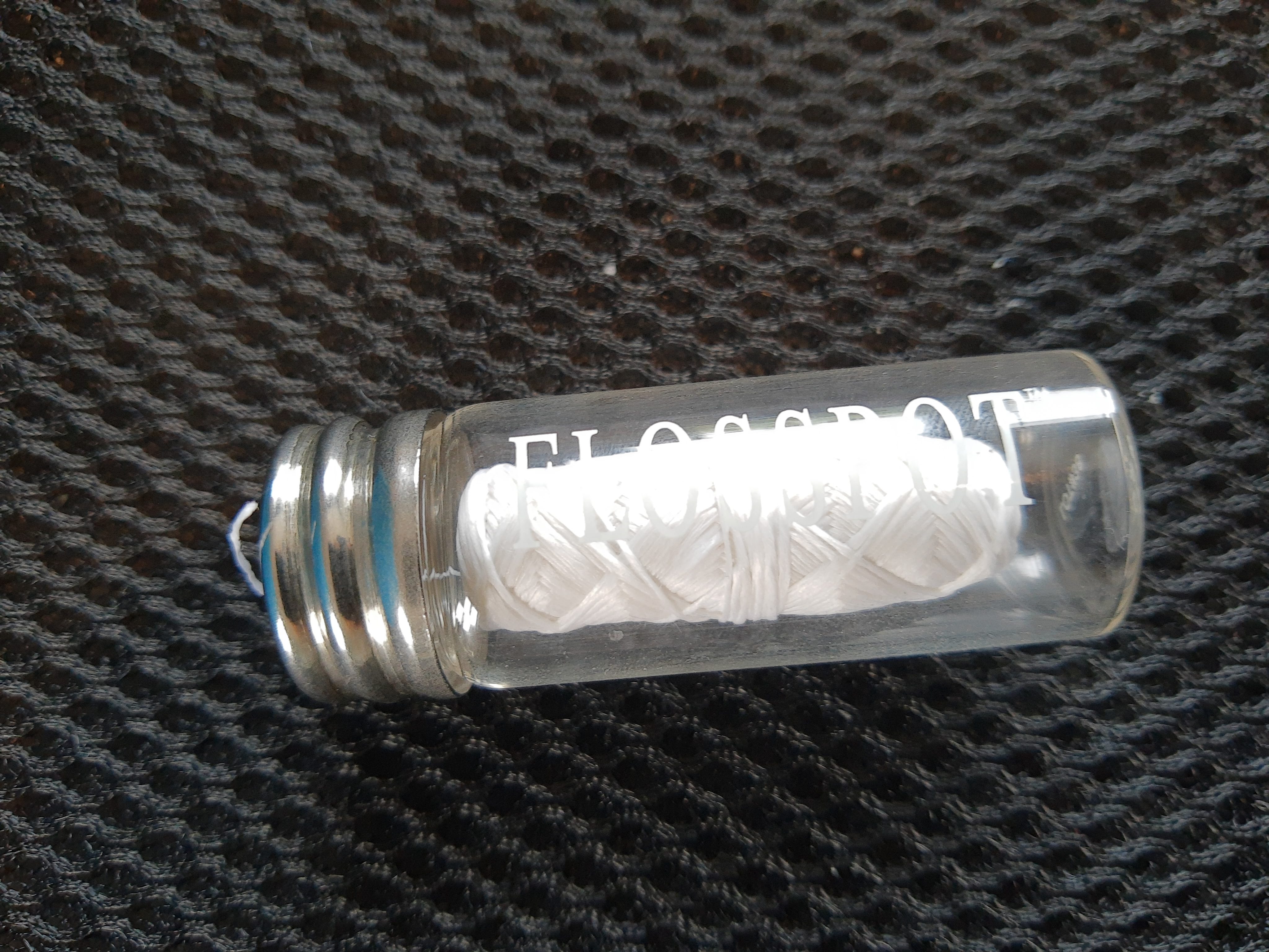 Dental floss in a glass jar